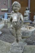 A small composite garden ornament modelled as a young boy.