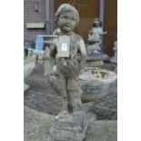 A small composite garden ornament modelled as a young boy.