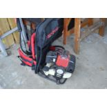 An Eckman back pack long handle hedge cutter with accessories.