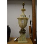 A large urn shaped alabaster table lamp.