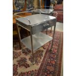 A stainless steel two tier single drawer trolley.