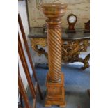 A pair of pine pedestal columns with wyrthen fluted column on a stepped square base.