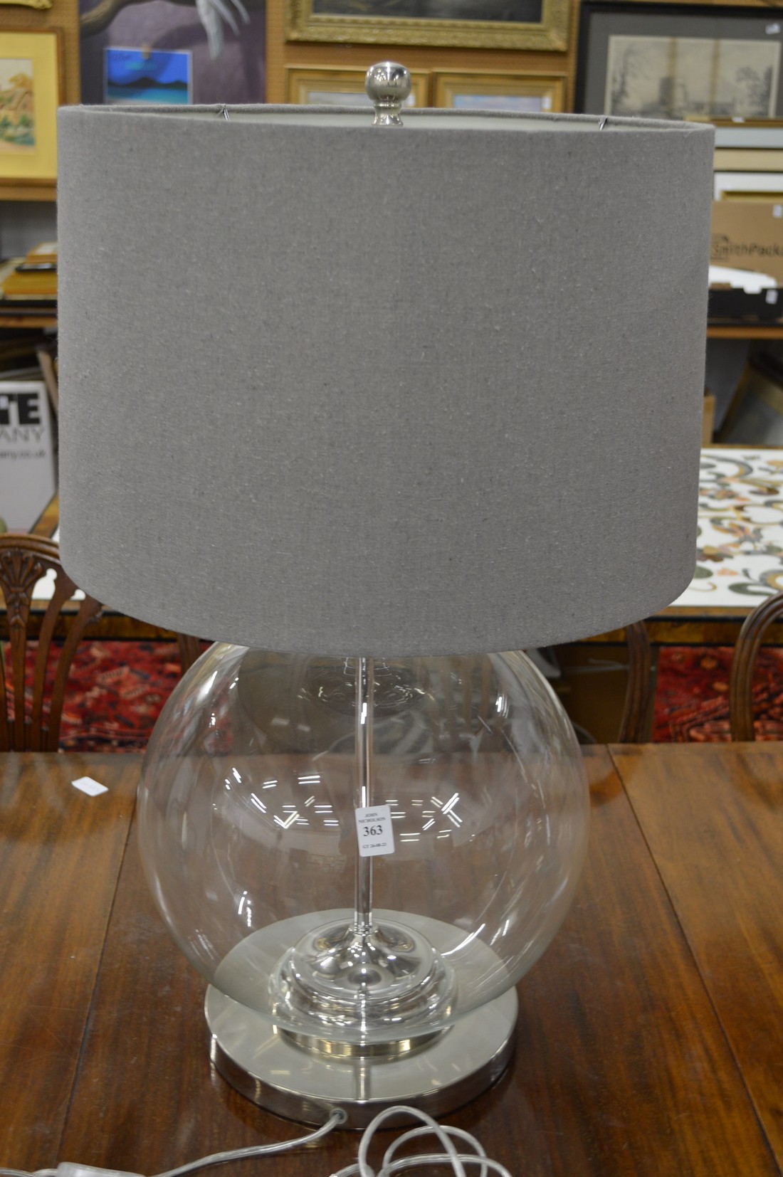 A large glass and chrome table lamp.