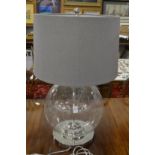 A large glass and chrome table lamp.