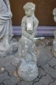 A composite garden ornament modelled as a seated female figure.