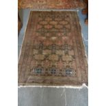 A Persian rug, early 20th century, brown ground with stylised decoration (worn) 180cm x 115cm.
