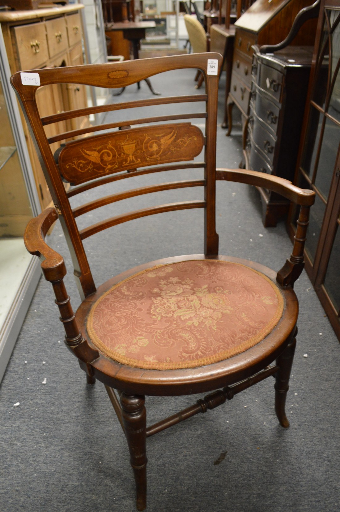 An Edwardian inlaid mahogany open armchair.