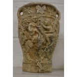 A large relief moulded pottery vase.