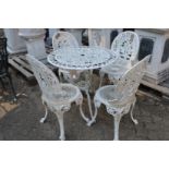 A white painted aluminium circular patio table with four chairs.