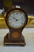 An Edwardian inlaid mahogany balloon shaped mantle clock, the enamel dial signed Harrods Ltd.