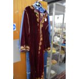 A middle Eastern red velvet housecoat.