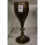 An engraved brass goblet.