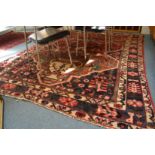 A Persian design carpet with stylised decoration 280cm x 206cm.