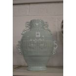 A Chinese pale turquoise ground vase with pierced handles and moulded decoration.