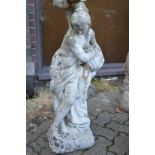 A composite garden ornament modelled as a classical standing female semi nude holding an urn.