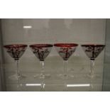 An unusual set of four cocktail glasses with engraved and etched decoration.