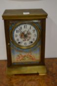 A brass mantle clock with Sevres style panels.