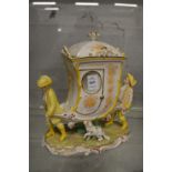 A Continental porcelain jar and cover modelled as two men carrying a sedan chair with a dog by there