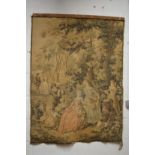 A machine made tapestry wall hanging depicting figures in a garden setting 130cm high x 95cm wide.