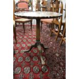 A George III design mahogany tilt top tripod table with carved pie crust border, fluted column on