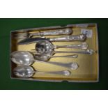 A group of silver flatware.