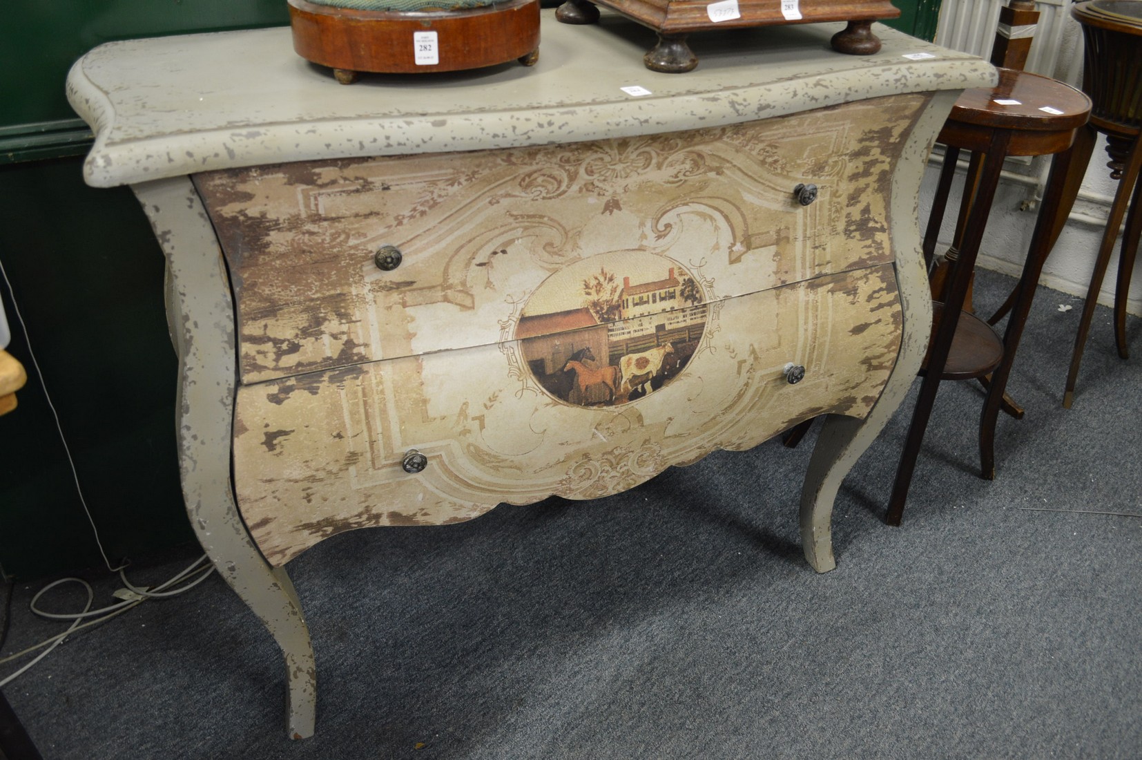 A decoratively painted French style two drawer commode.