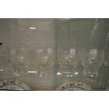 A set of four Walsh grape and vine engraved glass tumblers or wine glasses.