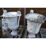 A large pair of carved marble twin handled urns on circular bases (af).