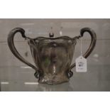 A good large Art Nouveau silver tyg or loving cup engraved with a crest.