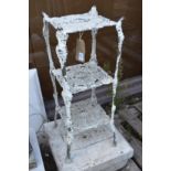 A white painted aluminium three tier plant stand.