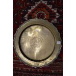 An engraved Eastern brass circular dish.