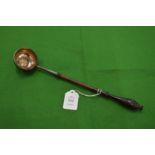 A coin inset silver toddy ladle.
