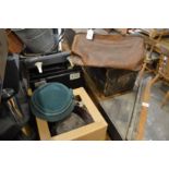 A leather doctors bag, box of hats and a sewing machine.