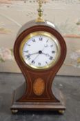An Edwardian inlaid mahogany balloon shaped mantle clock with enamel dial, eight day movement with