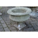 A small composite circular pedestal garden planter.