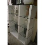 A large modern glass and laminated room divider/display unit.