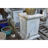 A pair of white marble square shaped plinths.