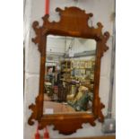 A walnut framed fretwork mirror.