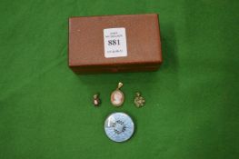 A small gold mounted cameo pendant, two decorative pendants and an enamel decorated silver brooch.