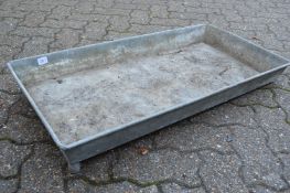 A rectangular galvanised trough or planter.