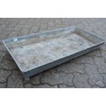 A rectangular galvanised trough or planter.