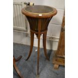 An Edwardian inlaid mahogany jardiniere with brass liner.