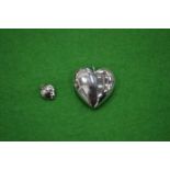 Two stainless steel heart pendants.
