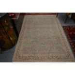 A Persian design rug beige ground with panels of floral decoration 215cm x 155cm.