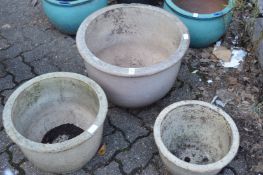 A graduated set of three buff glazed garden planters.