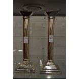 A pair of modern silver plated candlesticks.