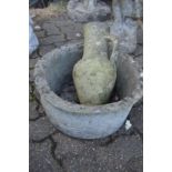 A Greek style jug and a basket weave style circular garden planter.