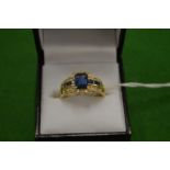 An 18ct gold diamond and synthetic sapphire ring size T.