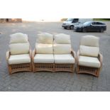 A bamboo three piece conservatory suite comprising two seater settee and pair of matching