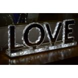 An illuminated sign 'love'.